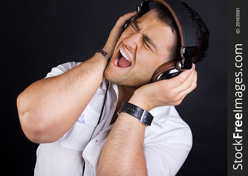 Young man is listening music and crying. Young man is listening music and crying