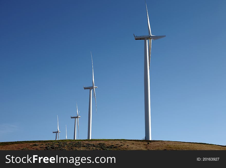 Wind turbines on top of a hill in Washington state. Wind turbines on top of a hill in Washington state.