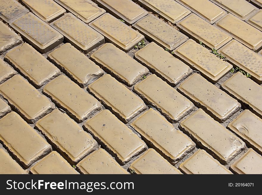 The old paving stones on the pavement close up. The old paving stones on the pavement close up