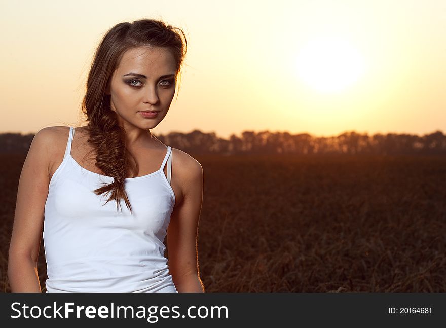 Woman in wheat field under blue sky