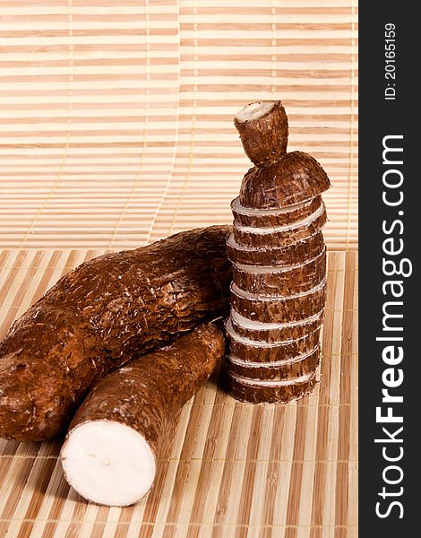 Close up view of the cassava root on a white background.