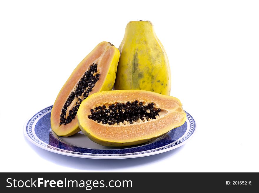 Close up view of papaya fruit sliced presented on a dish.