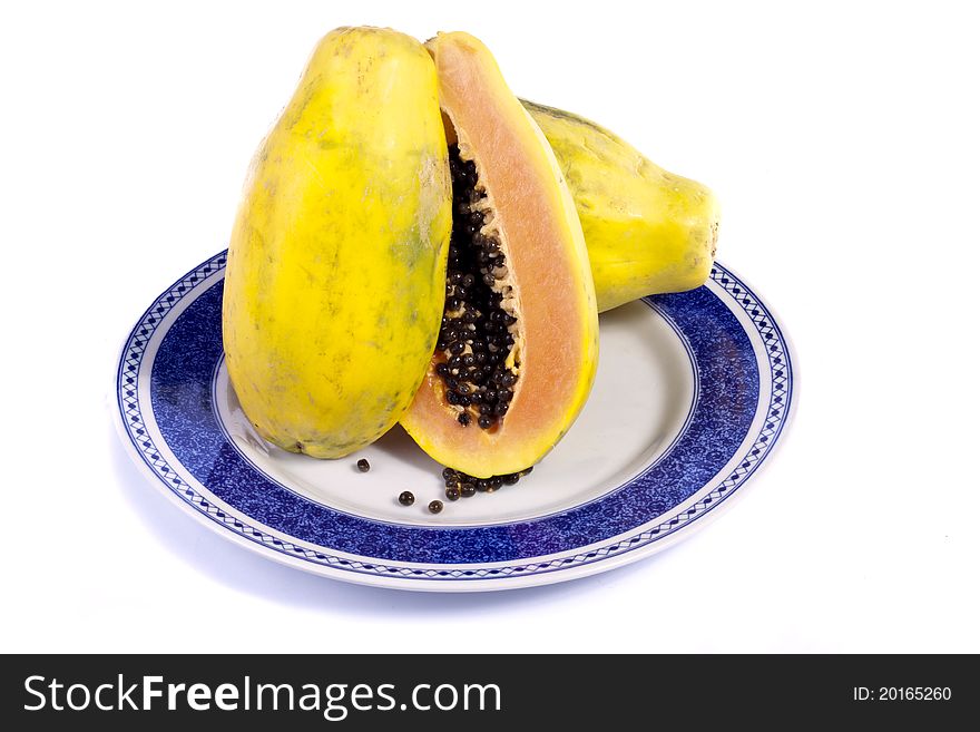 Close up view of papaya fruit sliced presented on a dish.