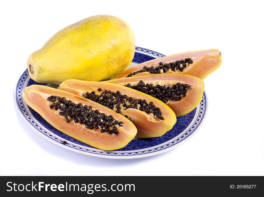 Close up view of papaya fruit sliced presented on a dish.