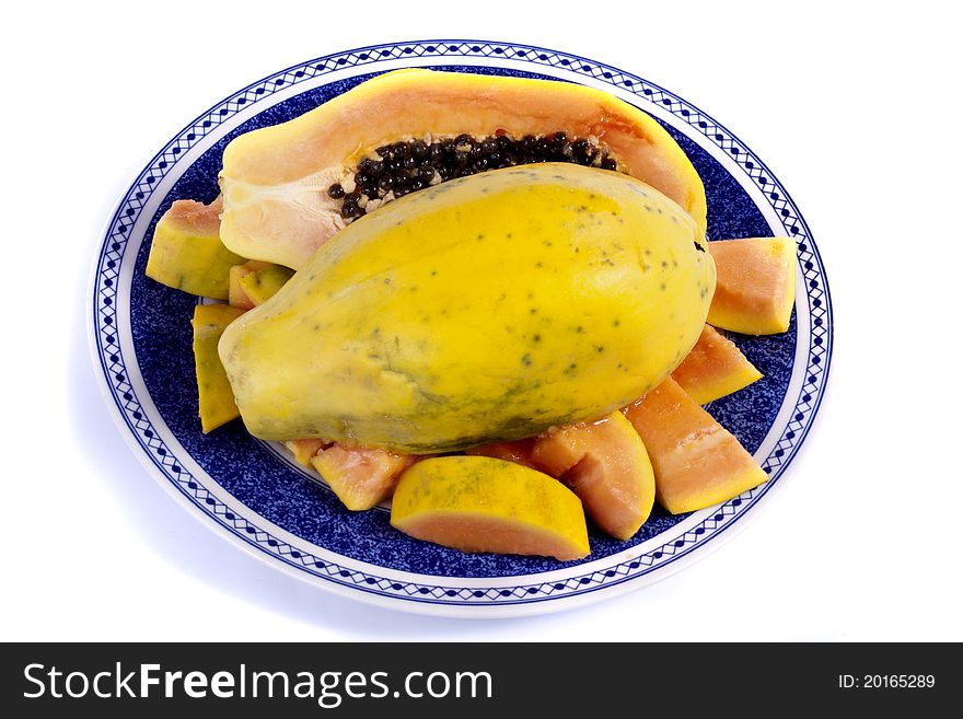 Close up view of papaya fruit sliced presented on a dish.