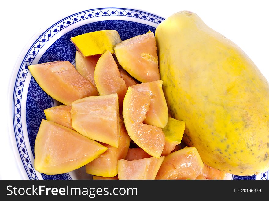 Close up view of papaya fruit sliced presented on a dish.