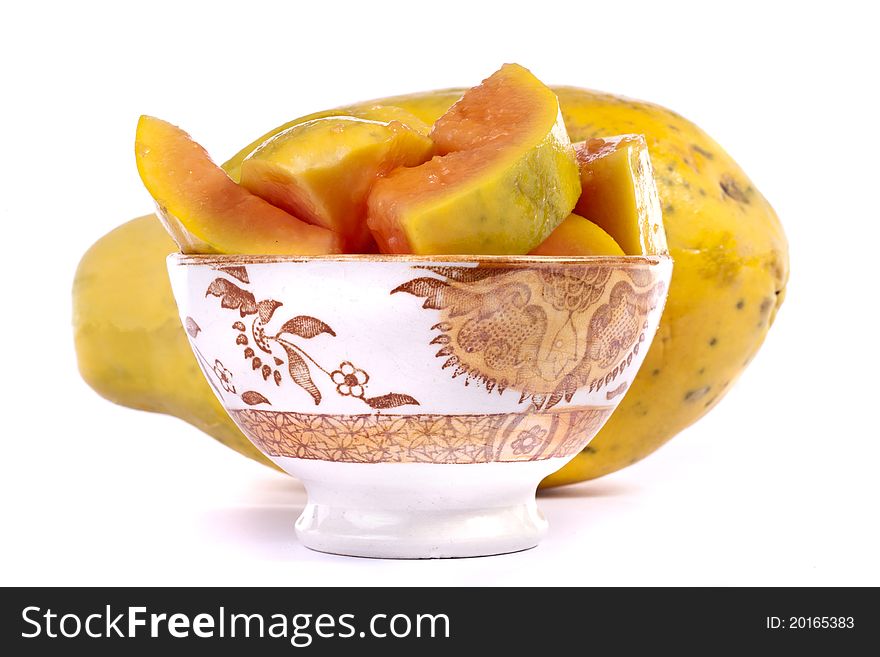 Close up view of papaya fruit sliced presented on a bowl.