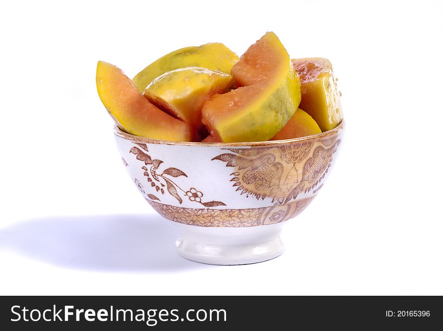 Close up view of papaya fruit sliced presented on a bowl.