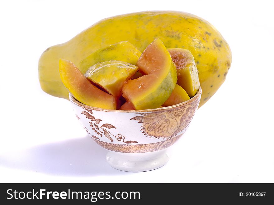 Close up view of papaya fruit sliced presented on a bowl.