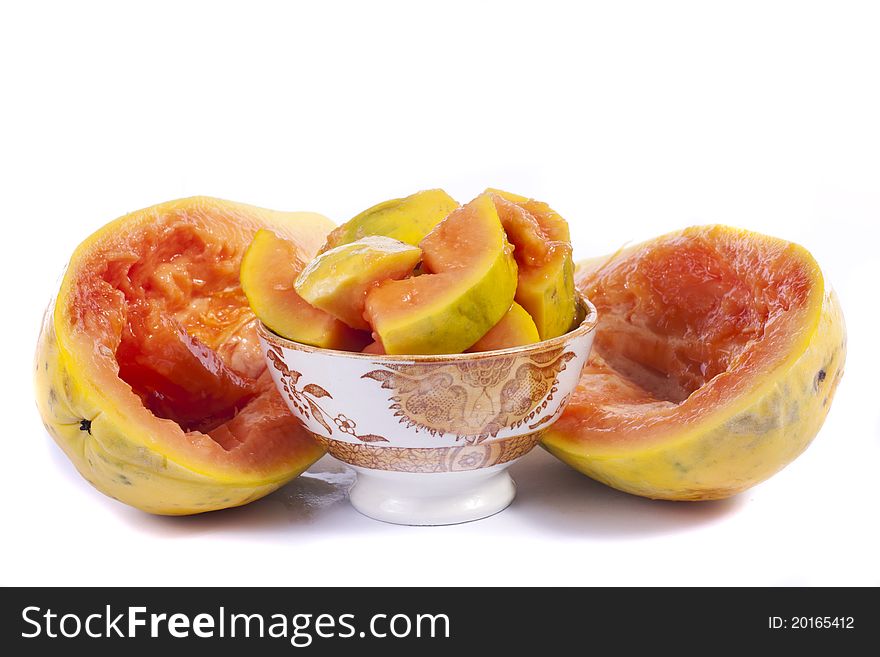 Close up view of papaya fruit sliced presented on a bowl.