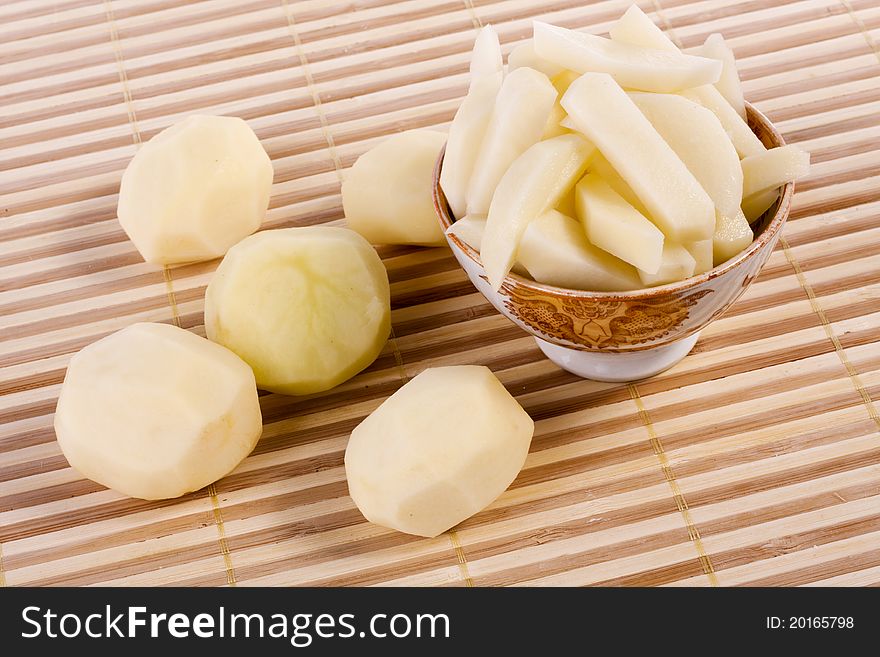 Close up view of some sliced potatoes  on bamboo background.
