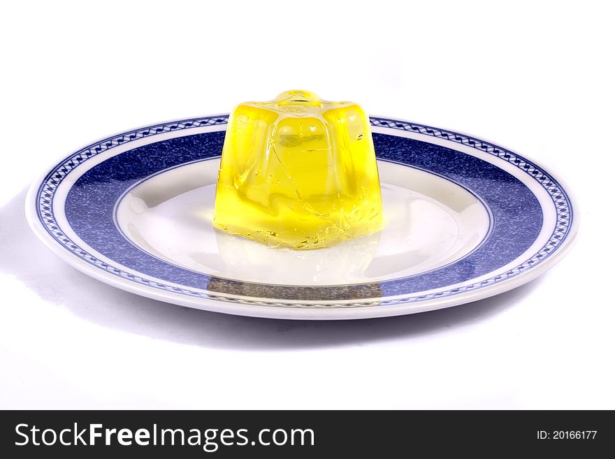 Close up view of a yellow gelatin isolated on a white background.