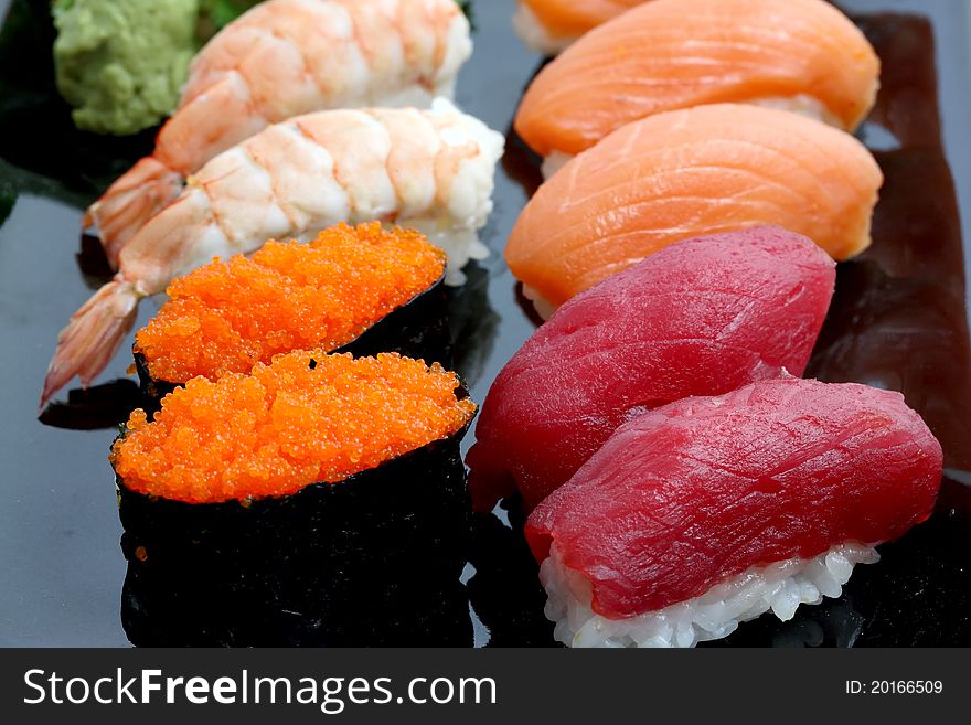 Sushi On Black Dish Isolated In White Background