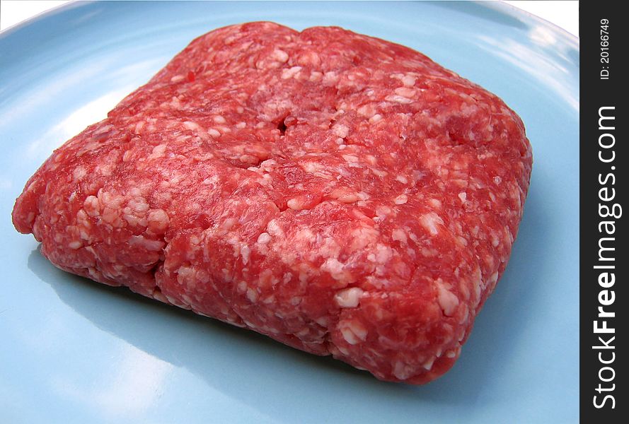 A close up photograph of raw mincemeat on a plate. A close up photograph of raw mincemeat on a plate.