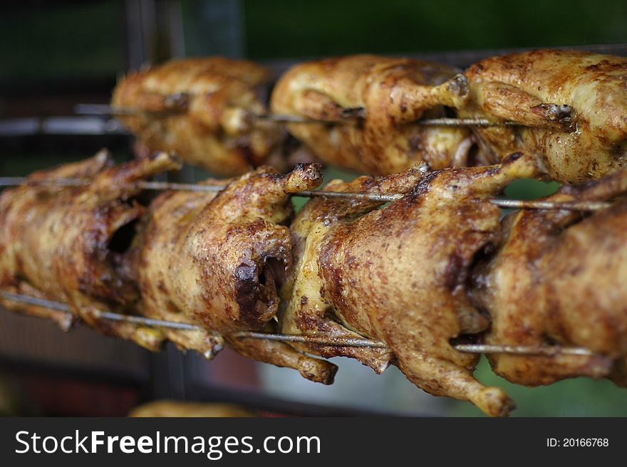 Seven grilled chicken on a spit