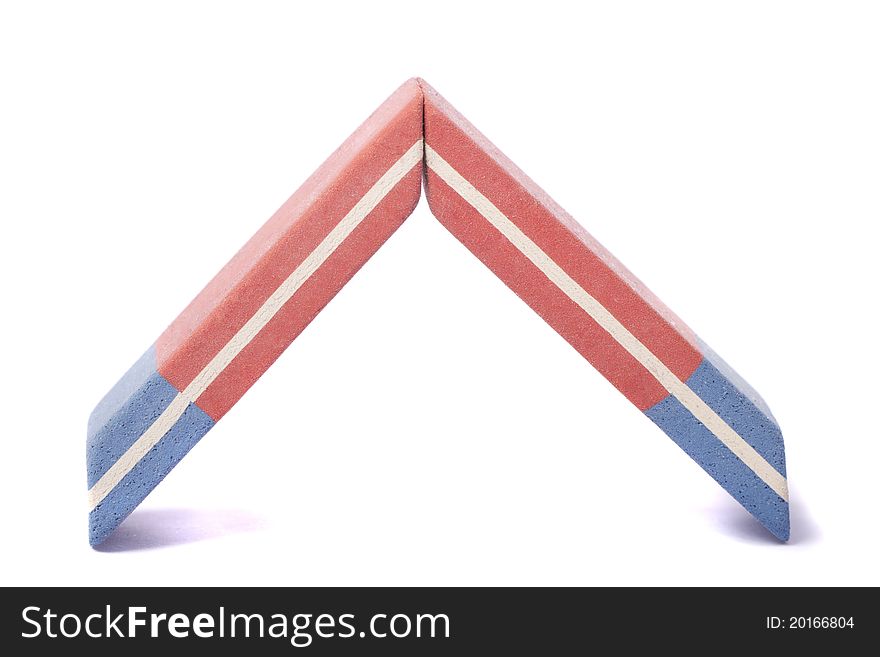 Close up view of a blue and red eraser isolated on a white background. Close up view of a blue and red eraser isolated on a white background.