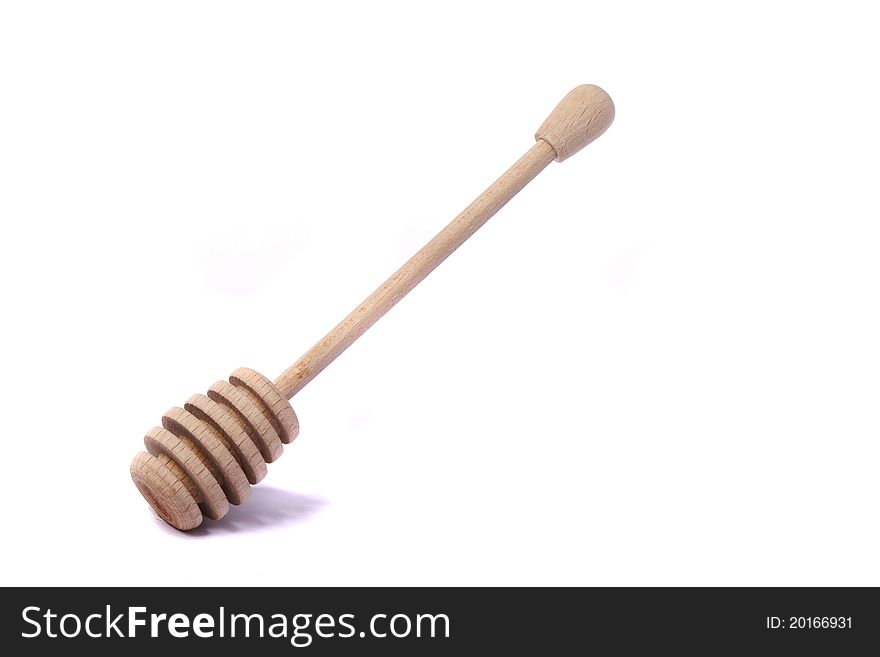 Close up view of a honey dipper utensil isolated on a white background.
