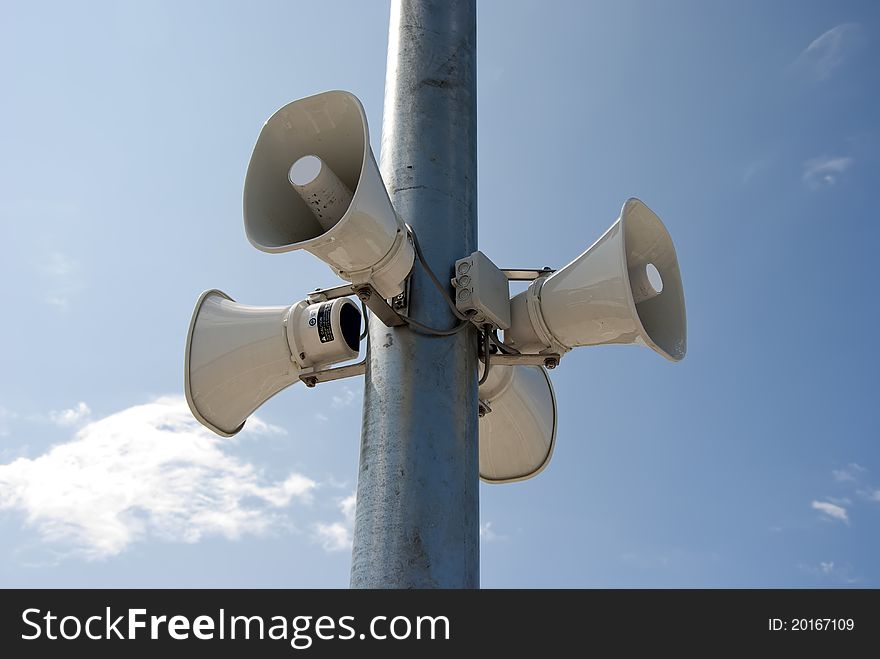Four megaphone hanging on a column. Four megaphone hanging on a column