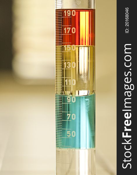 Close up view of a test tube with some different liquid solutions. Close up view of a test tube with some different liquid solutions.