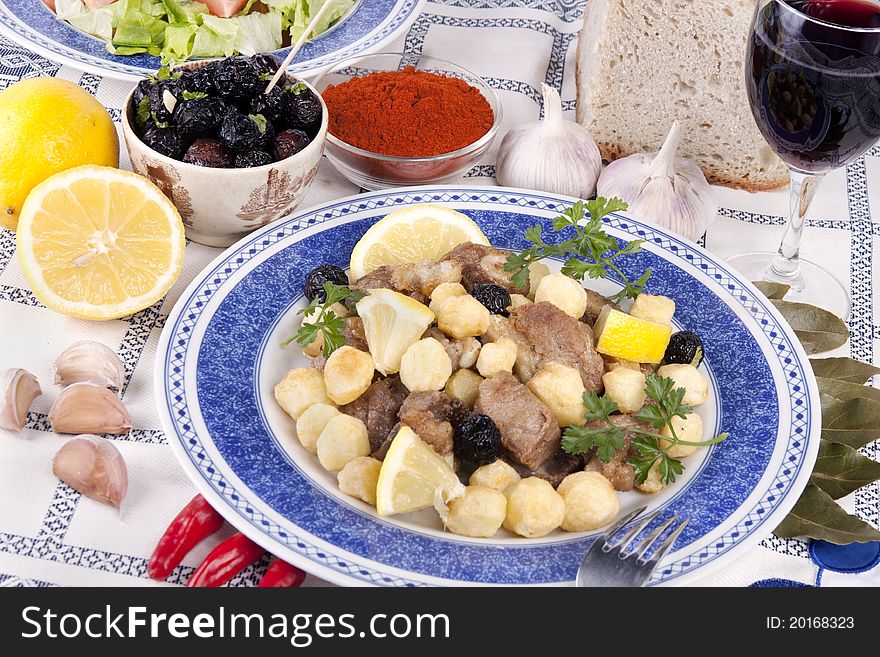 Close up view of a Portuguese meal of cooked meat with potatoes.