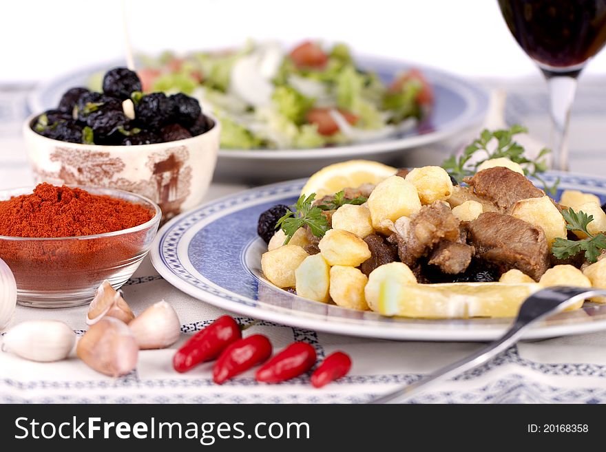 Close up view of a Portuguese meal of cooked meat with potatoes.