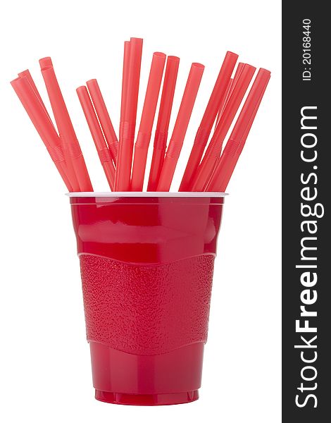 Red drinking straws in a red disposable cup isolated on a white background.