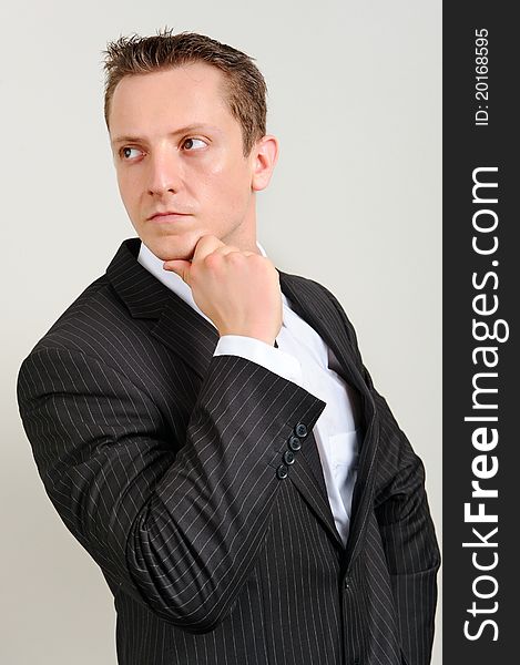 Attractive white executive is thinking in a smart suit. Attractive white executive is thinking in a smart suit