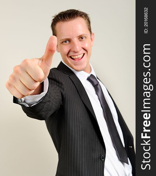 Cheerful and confident caucasian executive gives a thumbs up sign. Cheerful and confident caucasian executive gives a thumbs up sign