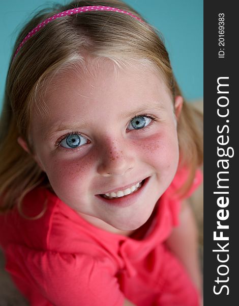 Cute young girl with bright blue eyes and freckles. Cute young girl with bright blue eyes and freckles