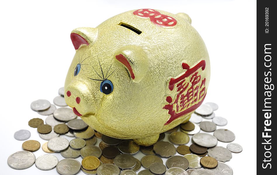 Chinese golden piggy bank on pile of coins.