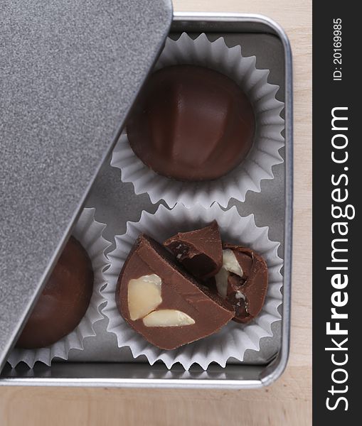 Chocolate nut truffles in silver metal box. Chocolate nut truffles in silver metal box