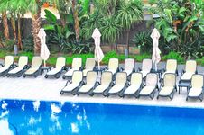 Plastic Chairs And Umbrellas Near Swimming Pool Royalty Free Stock Image Plastic Chairs And Umbrellas Near Swimming Pool Royalty Free Stock Image