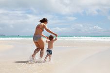 Mother And Son Having Fun On A Tropical Beach Stock Image