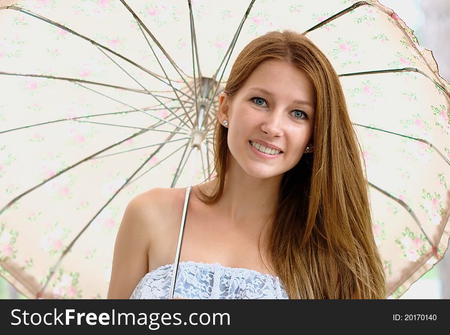 Portrait of a beautiful girl at the park with umbrella. Portrait of a beautiful girl at the park with umbrella