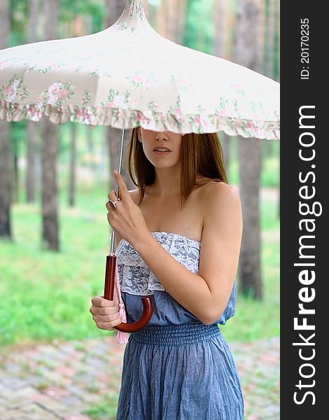 Portrait of a beautiful girl at the park with umbrella. Portrait of a beautiful girl at the park with umbrella