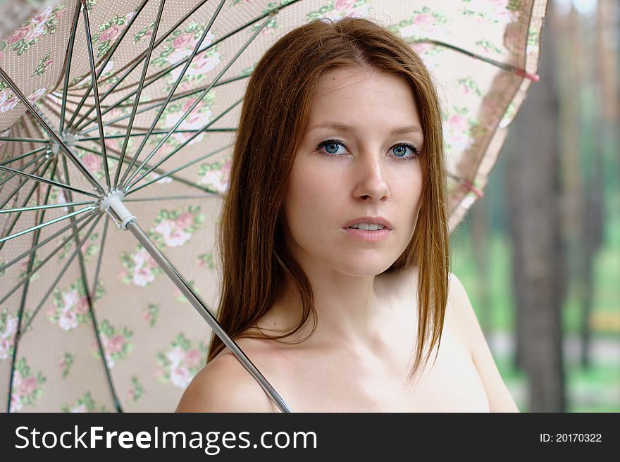 Portrait of a beautiful girl at the park with umbrella. Portrait of a beautiful girl at the park with umbrella