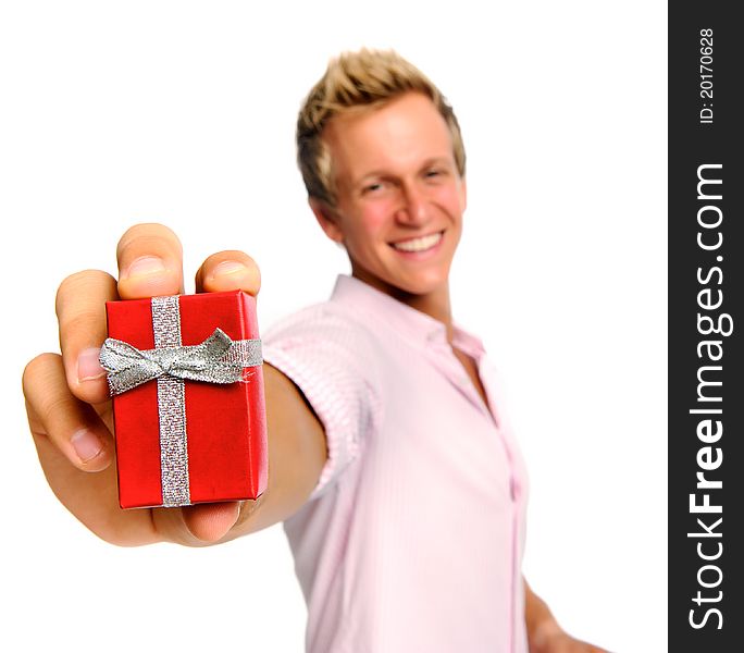 Happy blonde man holding a present for valentines day; selective focus on box. Happy blonde man holding a present for valentines day; selective focus on box