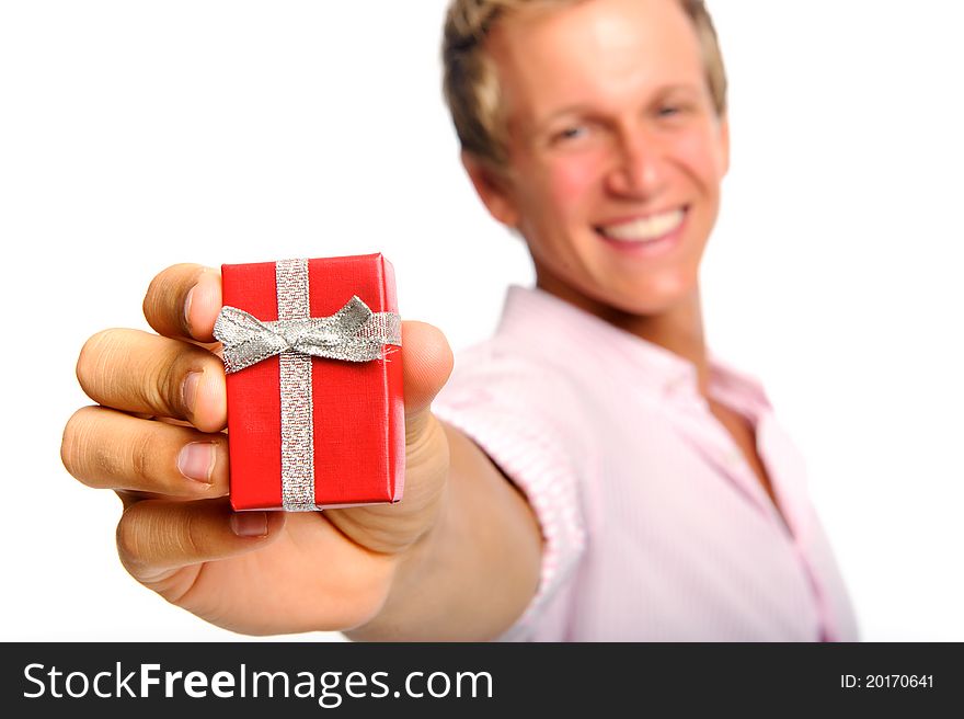 Happy blonde man holding a present for valentines day; selective focus on box. Happy blonde man holding a present for valentines day; selective focus on box