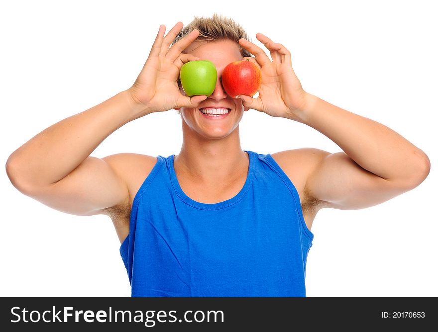 Smiling man holding two apples covering his eyes. Smiling man holding two apples covering his eyes
