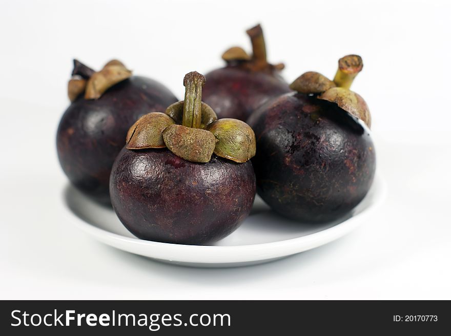 Mangosteens isolated on the white background.