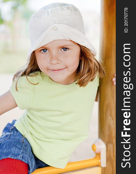 Small girl playing on children's playground