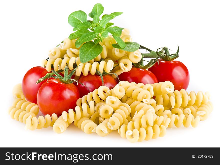 Fusilli pasta with tomatoes and basil over white background. Fusilli pasta with tomatoes and basil over white background