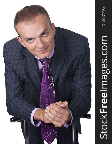 Portrait of a smiling young businessman standing against isolated white background