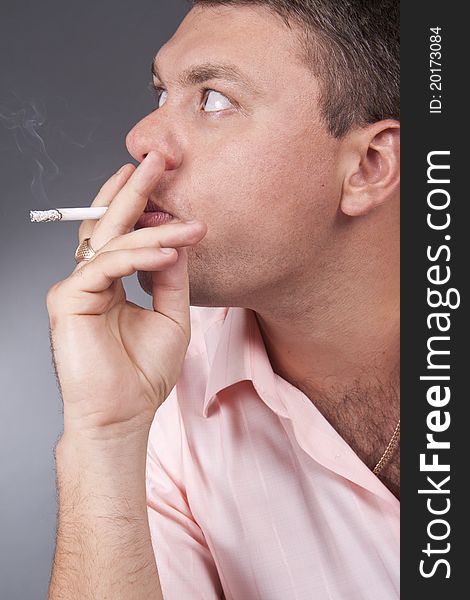 A Portrait Of A Young Man Smoking A Cigarette