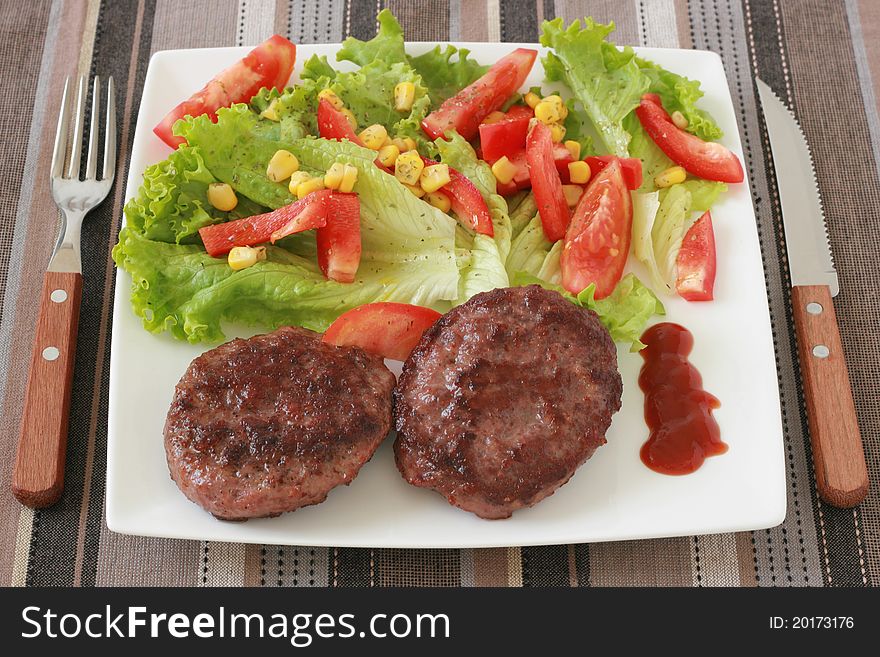 Cutlets with salad on a plate
