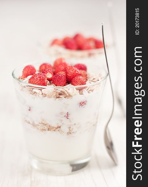 Natural yogurt with muesli and wild strawberries. Natural yogurt with muesli and wild strawberries