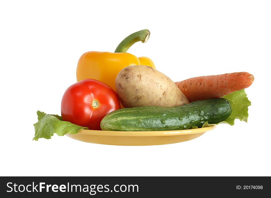Raw vegetables on plastic yellow plate. Isolated on white with clipping path