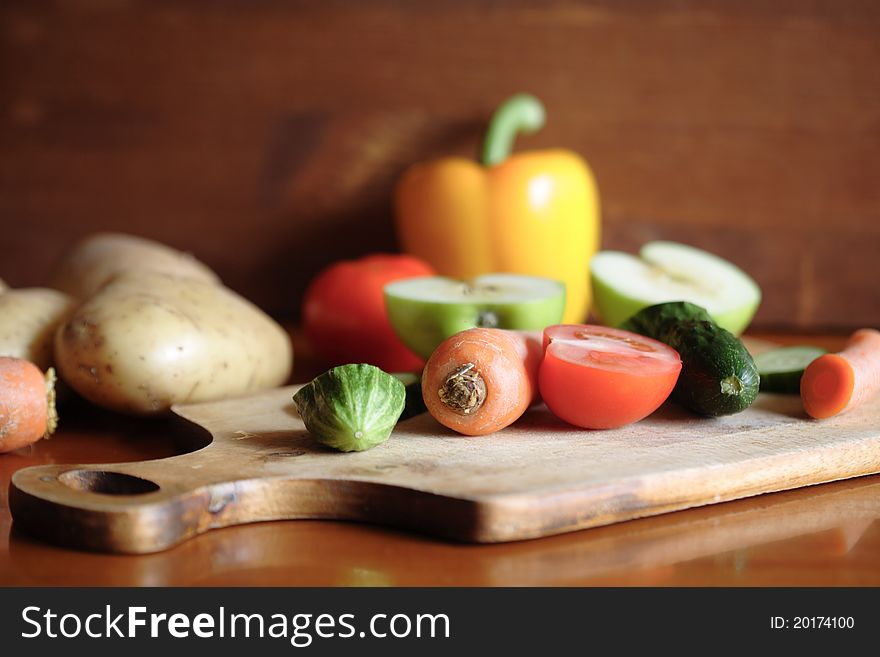 Closeup of various raw vegetables on wooden surface