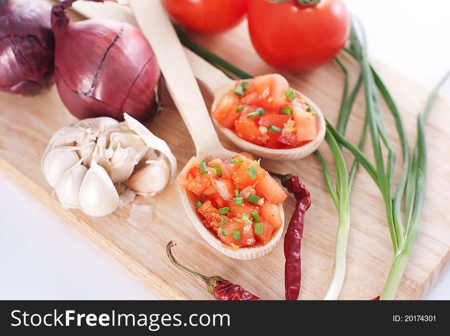Salsa on a wooden board and ingredients