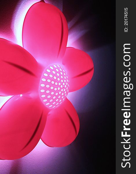 Funky and bright abstract pink flower light against black background. Funky and bright abstract pink flower light against black background.